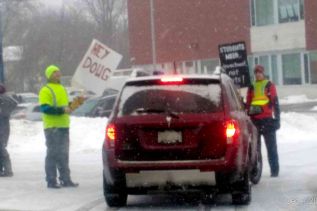 Picketers holding car carrying elementary students for two minutes at the entrance to GREC on Wednesday morning